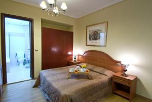 a bedroom with a bed with a table on it at Villa Elia in Veria