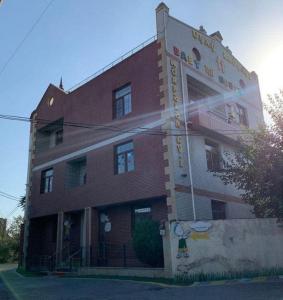 a red brick building with a sign on it at ALYAM Comfortable apartment In Baku in Baku