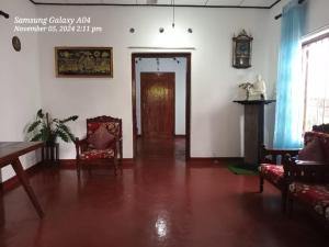 a living room with a table and chairs and a door at Lotus Paradise in Weligama