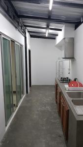 a kitchen with a counter and a sink in a room at Nido house in Ban Bang Phang
