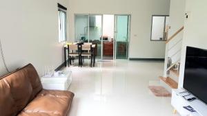 a living room with a couch and a table at Nido house in Ban Bang Phang