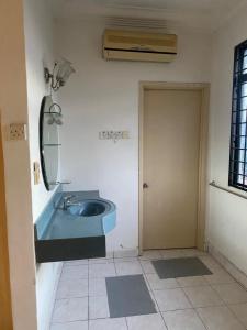 a bathroom with a blue sink and a mirror at Cityscape KL in Kuala Lumpur