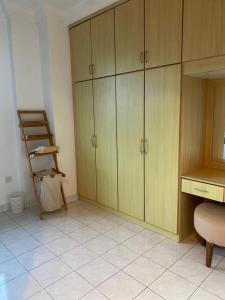 a kitchen with wooden cabinets and a table and a chair at Cityscape KL in Kuala Lumpur +7 photos