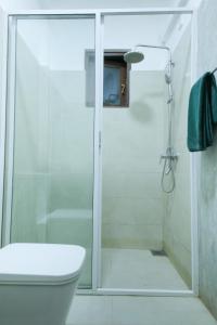 a shower with a glass door in a bathroom at Green Waters Resort by Aradhana Leisure in Embilipitiya