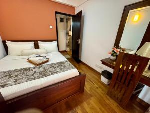 a bedroom with a bed with a purse on it at Highland View in Nuwara Eliya