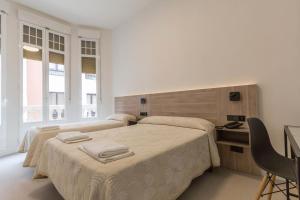 En eller flere senge i et værelse på Hostal Excelsior