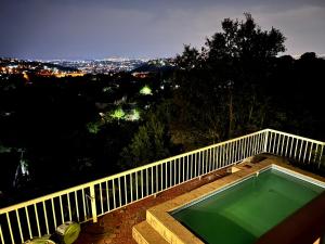 a swimming pool on the balcony of a house at Honeyhills Excellence Resort E in Roodepoort