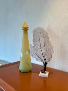 a plant sitting on a table next to a vase at Windjammer A3 - Sea View in Koksijde