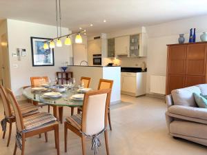 a dining room and kitchen with a table and chairs at Windjammer A3 - Sea View in Koksijde