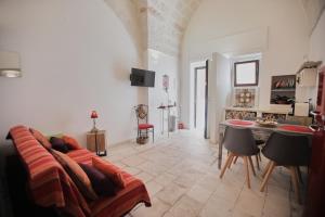 a living room with a couch and a table at Chez Liart 1 in Fasano