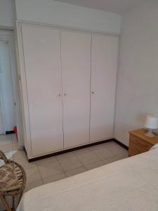 a bedroom with white cabinets and a bed at Apartamento frente a la Playa in Suances