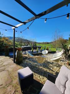 a patio with a view of boats on a river at La Esmeralda in Hornedo