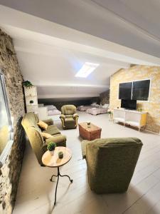 a living room with couches and a tv at La Esmeralda in Hornedo