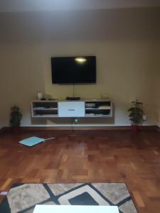 a living room with a flat screen tv on a wall at sunnyday in Johannesburg