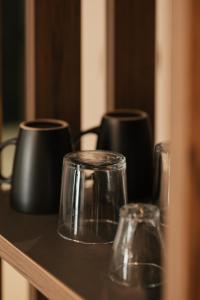 a table with three glass jars on a shelf at Bronze Suites in Ioannina