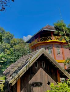 a wooden building with a tower on top of it at Swindo Homestay 77, Small House in Berastagi