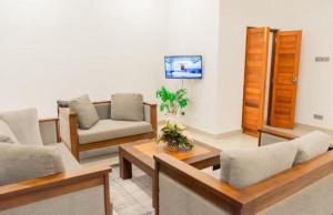 a living room with couches and a table at Blue Bird Hotels in Negombo