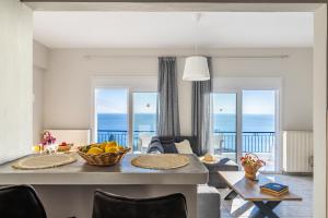 a living room with a table with a bowl of fruit at Andromachi's house in Loutraki
