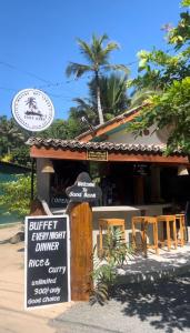 a restaurant with a sign in front of it at Sandbank Madiha deluxe bedroom with private bathroom in Matara