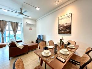 a living room with a table and chairs at Sunway Giza Nexis 1-10pax 4Qbed Kota Damansara Tropicana Mall in Petaling Jaya