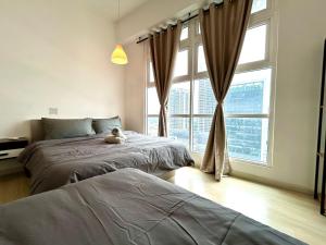 a bedroom with two beds and a teddy bear on the bed at Sunway Giza Nexis 1-10pax 4Qbed Kota Damansara Tropicana Mall in Petaling Jaya +34 photos