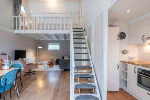 a loft conversion with a staircase and a living room at Groenendijk Verhuur Vakantiewoning de Haerde 52 in Ellemeet in Ellemeet