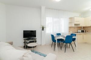 a kitchen and a living room with a table and chairs at ERA RENT Apartments 2 in Chişinău
