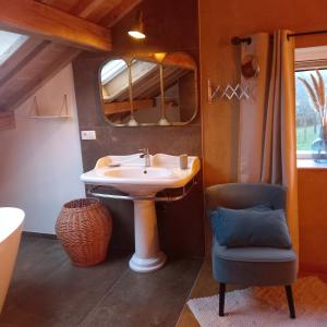 a bathroom with a sink and a chair at Le verger d' Adèle in Vielsalm +54 photos