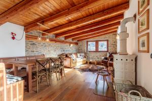 a living room with a wooden table and a fireplace at Le Chalet Des Vaches in Courmayeur