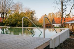 a boardwalk with metal hand rails on a body of water at Haus Sibylle in Bad Tölz
