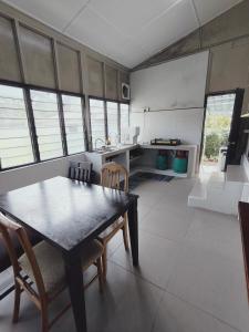 a kitchen with a table and chairs in a room at Rizkie homestay in Tanah Rata +12 photos