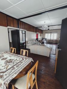a room with two beds and a living room at Rizkie homestay in Tanah Rata