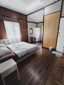 a bedroom with a large bed and a mirror at Rizkie homestay in Tanah Rata
