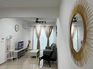 a living room with a mirror and a couch at Humaira - Metropol in Bukit Mertajam