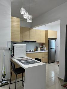 a kitchen with a counter and a stove top oven at Humaira - Metropol in Bukit Mertajam