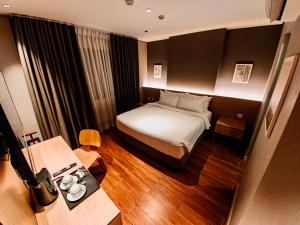 a hotel room with a bed and a desk at Moonstar Cebu Capsule Hotel in Cebu City