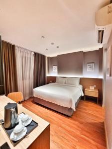 a hotel room with a bed and a table at Moonstar Cebu Capsule Hotel in Cebu City +8 photos