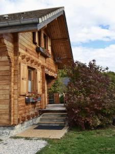 a log cabin with a porch and stairs leading to it at La Marmotte in Chorges