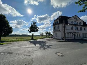 a large white building on the side of a road at Zur schönen Aussicht I 55 I Am Feld I Zuhause in Dortmund