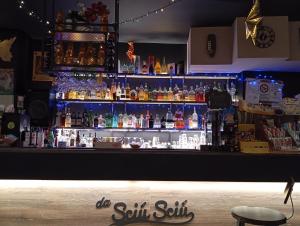 a bar filled with lots of bottles of alcohol at Vistuta di Vua in San Giovanni Gemini