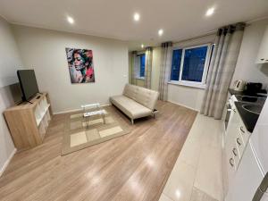 a living room with a couch and a kitchen at Central Location Apartment with Wide Bath in Tallinn +13 photos