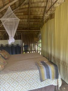 a bedroom with a bed with a canopy and curtains at Eco Casa Algana La Bambulera in El Limón +57 photos