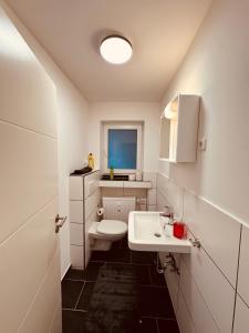 a bathroom with a white sink and a toilet at Zur schönen Aussicht I 55 I Am Feld I Zuhause in Dortmund +14 photos