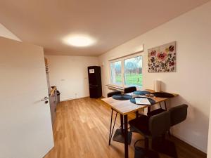a room with a desk and a kitchen with a window at Zur schönen Aussicht I 55 I Am Feld I Zuhause in Dortmund