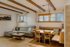 a living room with a couch and a table at Steinhäusl in Lofer