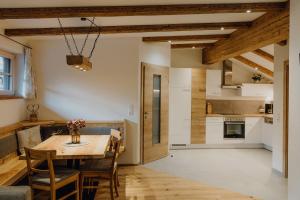 eine Küche und ein Esszimmer mit Tisch und Stühlen in der Unterkunft Steinhäusl in Lofer