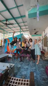 a group of people posing for a picture in a room at Dreamcatcher House & Hostel at Arambol Beach in Arambol