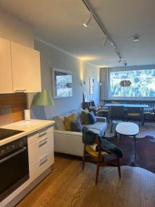 a kitchen and living room with a couch and a table at Art & View - Apartment in Bad Gastein