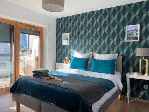 a bedroom with a large bed with blue pillows at Fred Appartement Lille Centre in Lille