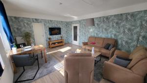 ein Wohnzimmer mit Sofa und Tisch in der Unterkunft FeWo-Butze 3 Esens in Esens